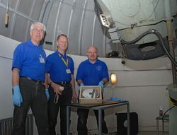 Mid-Kent Astronomical Society members Bob Tellervey, Noel Clark
  and Ian Hargraves pictured left to right with a telescope mirror.